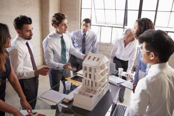 Architect presenting a design model to business colleagues