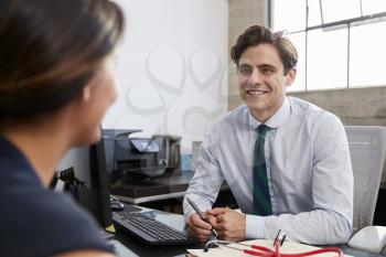 Young male professional in meeting with woman