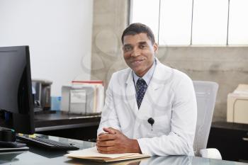 Mixed race  male doctor at desk, portrait