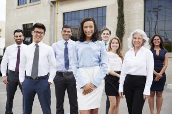 Young businesswoman and colleagues outdoors, portrait