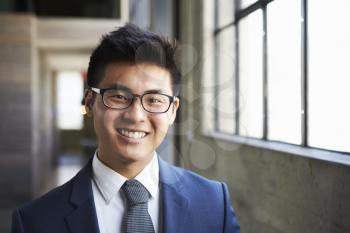 Young Asian businessman smiling to camera