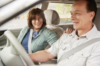 Woman passenger smiling at the driver during car road trip