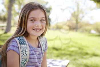 Young smiling schoolgirl looking to camera, portrait