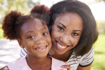 Portrait Of Smiling Mother With Daughter In Park