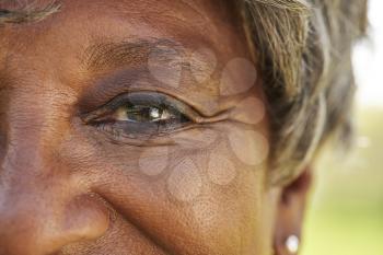 Close Up Of Smiling Senior Womans Eyes In Park