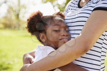 Close Up Of Mother Hugging Daughter In Park