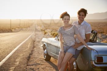 Portrait Of Romantic Couple Enjoying Road Trip In Classic Car