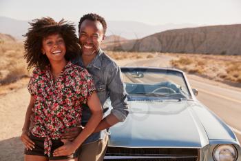 Young black couple on road trip having a roadside stop off