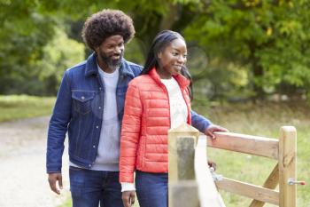 Man opening a gate for his girlfriend during a walk in the country, close up
