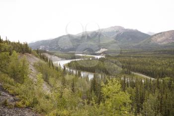 River Running Through Wooded Valley Between Mountains In Alaska