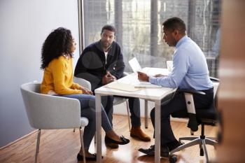Couple Meeting With Male Financial Advisor Relationship Counsellor In Office