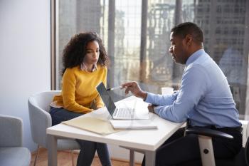 Woman Meeting With Male Financial Advisor Relationship Counsellor In Office