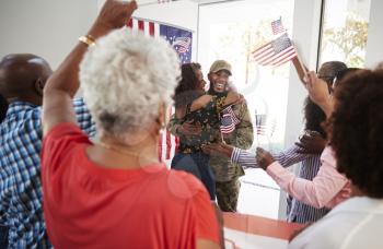 Young black soldier returning home to a surprise family party, selective focus