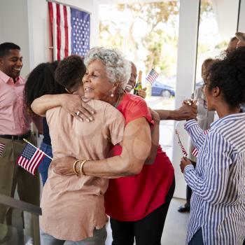 Senior black woman embracing her grandson at Independence Day family party,close up