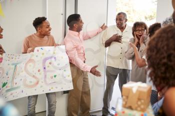 Senior black couple arriving home to a family surprise party, selective focus