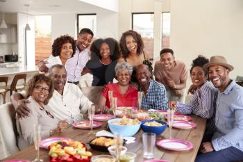 Senior black couples sitting at dinner table celebrating at home with family,selective focus
