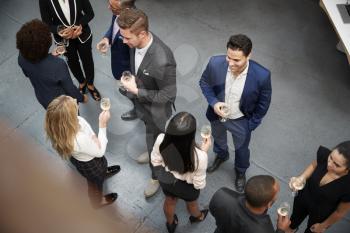 Overhead Shot Of Business Team Socializing At After Works Drinks In Modern Office