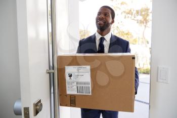 Businessman Carrying Box Opening Door Returning Home From Work