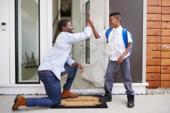 Father Giving Son High Five As He Leaves For School