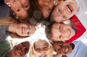 Group Of Multi-Cultural Children With Friends Looking Down Into Camera