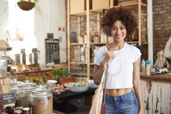 Portrait Of Woman Shopping In Sustainable Plastic Free Grocery Store
