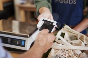 Customer Making Contactless Payment For Shopping At Checkout Of Grocery Store