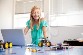 Female Student Building And Programing Robot Vehicle In After School Computer Coding Class
