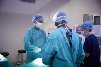 Surgical Team Working On Patient In Hospital Operating Theatre