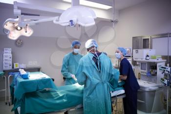 Surgical Team Working On Patient In Hospital Operating Theatre