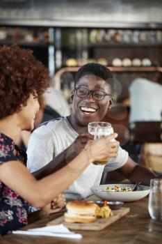 Couple On Date Meeting For Drinks And Food Making A Toast In Restaurant