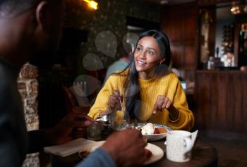 Couple At Table In Traditional English Pub Eating Breakfast