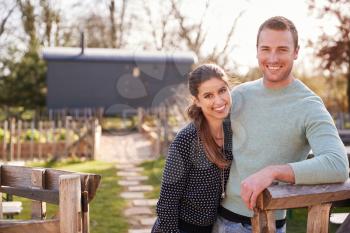 Outdoor Portrait Of Couple Spending Vacation In Eco Lodge
