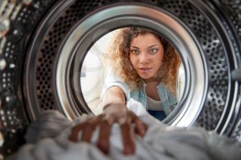 View Looking Out From Inside Washing Machine As Woman Does White Laundry