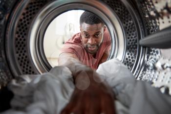 View Looking Out From Inside Washing Machine As Man Does White Laundry