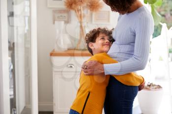 Loving Son Giving Mother Hug Indoors At Home