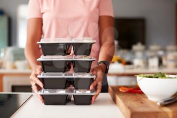Close Up Of Woman Preparing Batch Of Healthy Meals At Home In Kitchen
