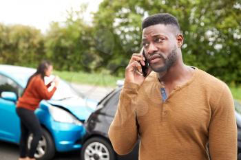 Male Motorist Involved In Car Accident Calling Insurance Company Or Recovery Service