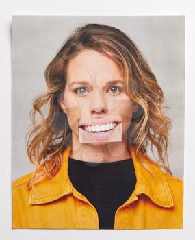 Identity Concept With Print Of Woman Showing Her Mouth Cut And Pasted Back Onto Her Face