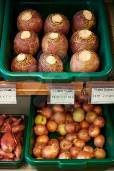 Display Of Swedes And Onions In Organic Farm Shop