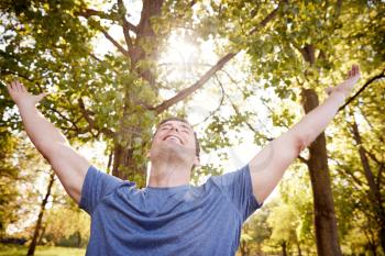 Man Outdoors In Fitness Clothing Stretching Arms And Celebrating Nature