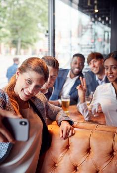 Group Of Business Colleagues Posing For Selfie In Bar After Work