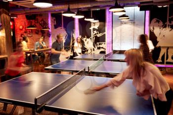 Interior Of Bar With Customers Drinking And Playing Table Tennis