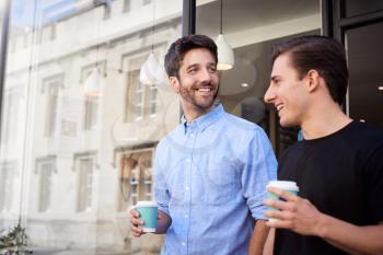 Male Gay Couple On Date Coming Out Of Coffee Shop Together