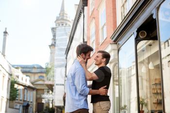 Loving Male Gay Couple Hugging Outside In City Street