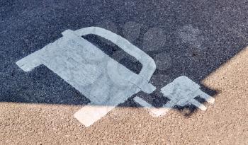 Painted Road Sign Indicating Electric Vehicle Recharging Parking Point