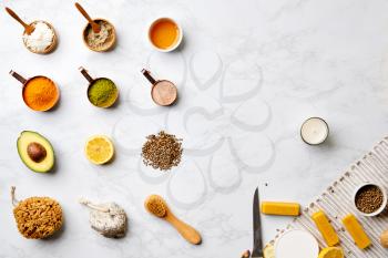 Overhead View Of Natural Beauty And Health Products In Measuring Cups On Marble Background