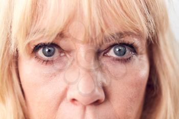 Studio Close Up Of Mature Woman Looking Suspicious And Distrustful