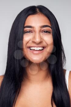 Studio Portrait Of Positive Happy Young Woman Smiling At Camera