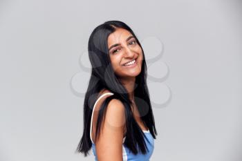Studio Portrait Of Positive Happy Young Woman Smiling At Camera