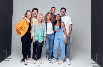 Group Studio Photo Shoot Of Young Multi-Cultural Friends Smiling And Laughing At Camera